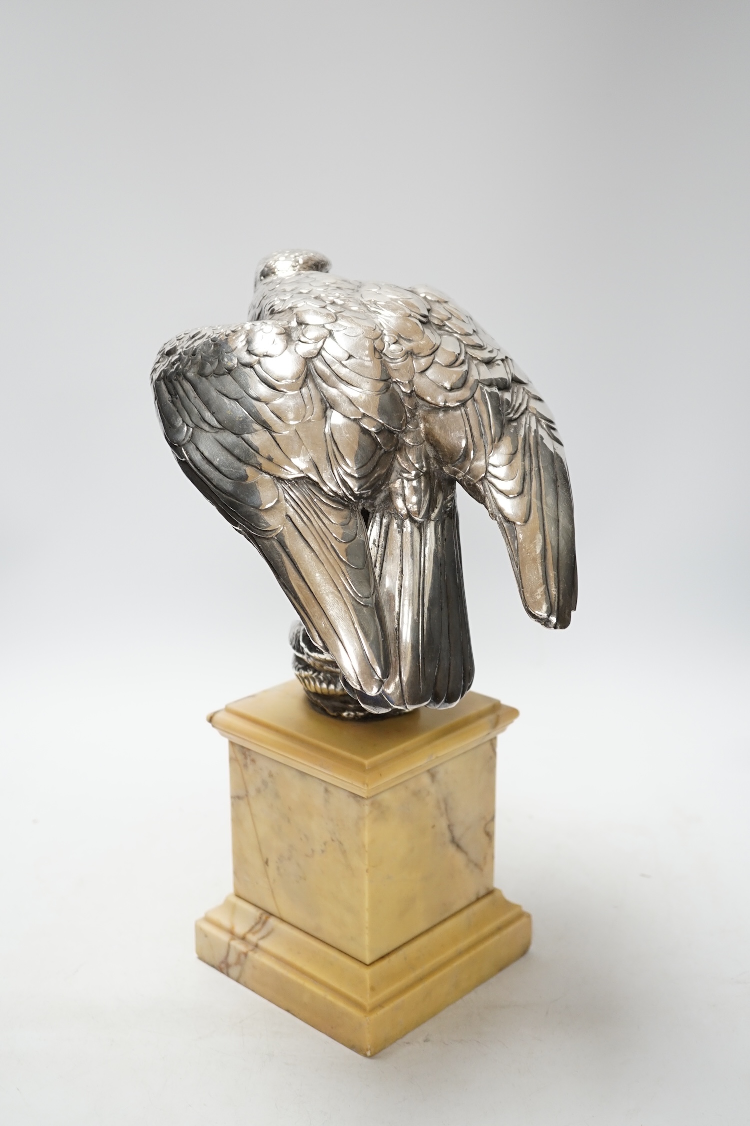 A silvered bronze falcon and serpent group, on marble pedestal, 37cm